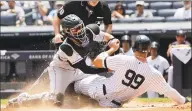  ?? Frank Franklin II / Associated Press ?? Rockies catcher Tony Wolters tags out the Yankees’ Aaron Judge during the first inning on Saturday.