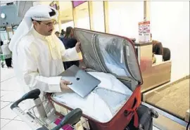  ?? Yasser Al-zayyat AFP/Getty Images ?? PASSENGERS on f lights to the U.S. from eight Middle Eastern and African countries are banned from carrying on electronic devices larger than a cellphone.