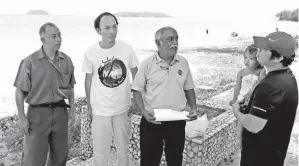  ??  ?? MUTHU (tengah) sempat berbual dengan pengunjung dan berkongsi pandangan tentang keadaan di Pantai Tanjung Aru.