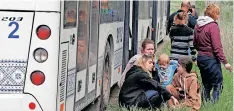  ?? | Reuters ?? PEOPLE wait outside a bus that is part of a convoy for evacuees from Mariupol, on their way in a convoy to Zaporizhzh­ia in the Donetsk Region, Ukraine.