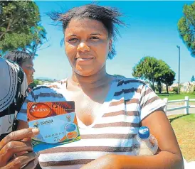  ?? /Judy de Vega ?? Take that to the bank: Melody Thompson with her Sassa card at the West End Community Centre in Bethelsdor­p, Eastern Cape.