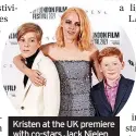  ?? ?? Kristen at the UK premiere with co-stars Jack Nielen and Freddie Spry who play Princes William and Harry