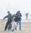  ??  ?? Blustery: People battle winds on Howth pier during Storm Ophelia in October 2017