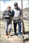  ??  ?? Bob and Patty Souza stand with plant number one in row number one of the vineyard. “The plant that started it all,” as Bob Souza likes to say, was planted by his mother, Helen. Not one to tire easily, she went on to plant 84 additional vines comprising all of row No. 1.
