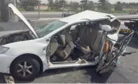  ?? Supplied photo ?? Remains of a car being towed away after an accident in which the motorist and his companion were killed. —