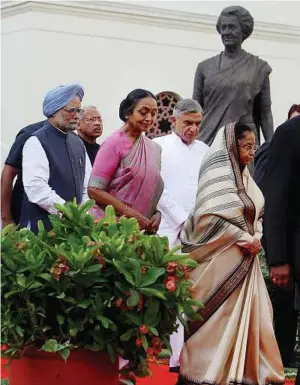  ??  ?? Troubles put aside: Manmohan Singh (left) and Speaker of the Lower House Meira Kumar (third from right) arriving to attend a special session held to mark the 60th anniversar­y of the Indian parliament in New Delhi. A statue of former Prime Minister...