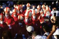  ?? (AP/Salvador Melendez) ?? Catholic bishops walk to the main altar Saturday in San Salvador, El Salvador, during a beatificat­ion ceremony for two priests and two lay people, all victims of right-wing death squads during El Salvador’s civil war.