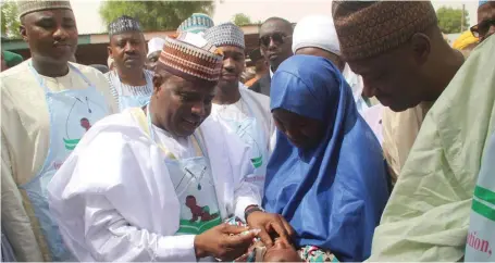  ??  ?? Sokoto State Governor Aminu Waziri Tambuwal (left), administer­ing the polio vaccine to a baby, at Bodinga, Sokoto State...yesterday