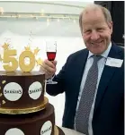  ??  ?? Michael Barker with the 50th anniversar­y cake.