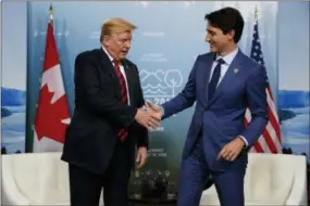  ??  ?? U.S. President Donald Trump shakes hands with Canadian Prime Minister Justin Trudeau during a meeting at the G-7 summit, Friday, June 8, 2018, in Charlevoix, Canada. (AP Photo/Evan Vucci)