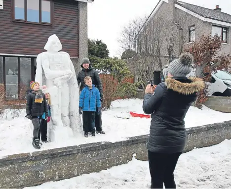  ??  ?? A 9ft-TALL Darth Vader snowman became the centre of attention in a city garden.
Douglas Roulston, 33, created the Star Wars character — taking advantage of some unexpected time off after classes were suspended at Forfar Academy, where he teaches art,...