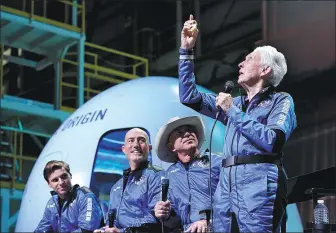  ?? TONY GUTIERREZ / ASSOCIATED PRESS ?? Former pilot Wally Funk gives an animated account of her trip into space on Tuesday. With her at the spaceport near Van Horn, Texas, are fellow voyagers (from left) Oliver Daemen, Mark Bezos and Jeff Bezos, founder of space tourism company Blue Origin.