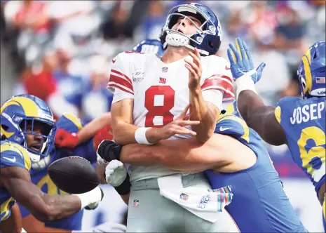  ?? Rich Schultz / Getty Images ?? The Rams’ Leonard Floyd strip sacks the Giants’ Daniel Jones in the first quarter on Sunday at MetLife Stadium in East Rutherford, N.J.