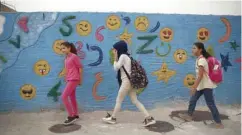  ??  ?? Syrian children walk to school in the northern city of Azaz in the rebel-held region of Aleppo province, near the border with Turkey. — AFP