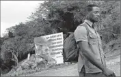  ?? Carolyn Cole Los Angeles Times ?? A SIGN in Mariel, Cuba, says, “... and I will be on the front line, to die fighting in defense of my nation.” Military service is mandatory for young Cubans.