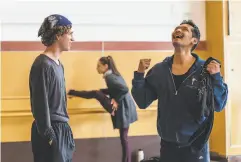  ??  ?? Top: Students warm up for the first inperson class in more than a year on Monday, July 5, at Alonzo King Lines Dance Center. Above: Tai Lum (left) and Victor Talledos share a moment before the class.