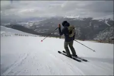  ?? BRITTANY PETERSON — THE ASSOCIATED PRESS ?? A skier goes down a hill at Arapahoe Basin Ski Area on Jan. 20 in Dillon. As global warming threatens to put much of the ski industry out of business over the next several decades, resorts are beginning to embrace a role as climate activists.