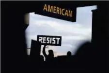  ?? AP PHOTO/COREY PERRINE ?? In this Jan. 29, 2017 file photo, a protester holds up a sign during a protest of President Donald Trump’s executive order banning travel to the U.S. by citizens of Iraq, Syria, Iran, Sudan, Libya, Somalia or Yemen at Philadelph­ia Internatio­nal Airport.