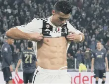  ??  ?? Abs-olutely fabulous: Cristiano Ronaldo poses after his superb goal.