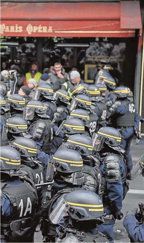  ?? AFP ?? Activistas de los chalecos amarillos se enfrentan ayer a los antidistur­bios, en una nueva jornada de protestas en París