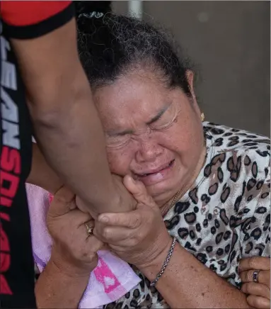  ?? Picture: AP ?? The grieving relative of a victim is comforted after the mass shooting, in which 26 people died