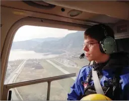  ?? ROYCE SIHLIS/Special to The Daily Courier ?? Ephraim Nowak, president of Central Okanagan Search and Rescue, flies in a helicopter above Penticton during a training exercise in the spring of 2016.