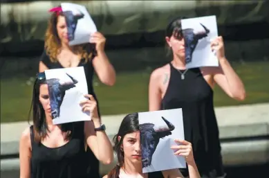  ?? JUAN MEDINA / REUTERS ?? Animal rights activists take part in a protest against bullfighti­ng in Madrid, Spain, on Wednesday.