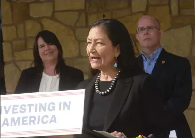  ?? (NWA Democrat-Gazette/Flip Putthoff) ?? U.S. Secretary of the Interior Deb Haaland speaks in Springdale on Wednesday as Beaver Watershed Alliance Executive Director Becky Roark (left) and Chris Davidson with the U.S. Fish and Wildlife Service in Arkansas look on.