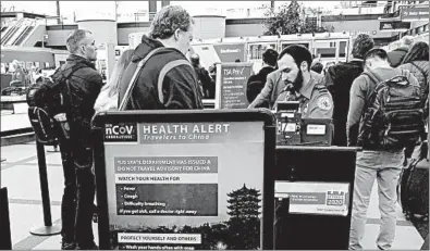  ?? CHARLES REX ARBOGAST/AP ?? A health alert for people traveling to China is shown at a TSA security checkpoint at Denver Internatio­nal Airport.