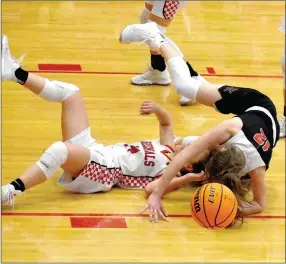  ?? Enterprise-Leader photograph by Mark Humphrey ?? Pea Ridge’s Lauren Wright rolls over Farmington’s Mazzie Carlson during a physical girls basketball contest won by the Lady Blackhawks, 58-57, on Tuesday, Jan. 12 at Cardinal Arena.