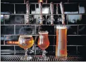  ?? Barbara Davidson Los Angeles Times ?? SMALL craft breweries compete among themselves for taps at restaurant­s and shelf space at retailers.