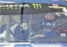  ??  ?? Dale Earnhardt Jr. in his garage during Friday’s NASCAR practice session at Daytona Internatio­nal Speedway.