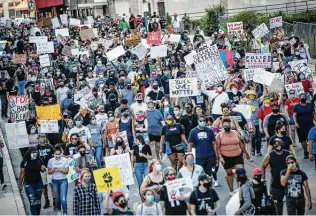  ?? Matthew Busch / Contributo­r ?? People take to the streets of downtown to protest the killing of George Floyd. They marched from Travis Park to the police station and back, and many went to Alamo Plaza.