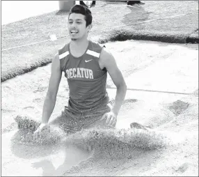  ?? Westside Eagle Observer/MIKE ECKELS ?? Decatur’s Jimmy Mendoza pushes up a wave of dirt after landing during the long jump at the Blackhawk Invitation­al Relays in Pea Ridge on April 5. Mendoza placed sixth in this event and first in the triple jump for Decatur.