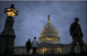  ?? J. SCOTT APPLEWHITE — ASSOCIATED PRESS FILE PHOTO ?? On Jan. 21, lights illuminate the U.S. Capitol on second day of the federal shutdown as lawmakers negotiate behind closed doors in Washington. The era of trillion-dollar budget deficits is about make a comeback — and a brewing budget deal hastened the...