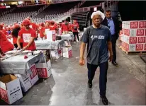  ?? BRANDEN CAMP / SPECIAL TO THE AJC ?? U.S. Rep. John Lewis, D-Atlanta, makes his way to help pack meals during the pack 1 million meals event last week at State Farm Arena.