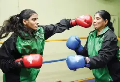  ??  ?? KARACHI: In this photograph taken on October 6, 2016, 19-year-old Pakistani boxer Razia Banu (L) throws a punch at her mother Haleema Abdul Aziz during a practice session at the Pak Shaheen Boxing Club in Karachi. —AFP