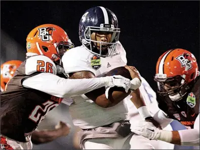  ?? AP/AL.com/MIKE KITTRELL ?? Georgia Southern quarterbac­k Kevin Ellison is wrapped up by Bowling Green’s Alfonso Mack (26) in the first half of the Eagles’ 58-27 GoDaddy Bowl victory Wednesday in Mobile, Ala. It was Georgia Southern’s first-ever bowl victory.