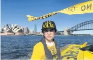  ??  ?? Ambrose Hayes, a 15-year-old climate change activist, rides on a barge during an event as part of the Fund Our Future Not Gas climate rally in Sydney Harbour yesterday.