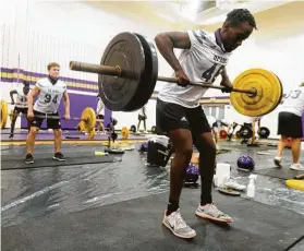  ??  ?? Defensive lineman Daniel Miregi and his Montgomery teammates are properly social distanced for a lifting session in the school gym.