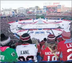 ?? | AP PHOTO ?? Fans of the Washington Capitals and the Blackhawks watch their teams play during the third period of the Winter Classic on Thursday at Nationals Park in Washington, D.C.
