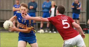  ??  ?? Mark Rossiter of Gusserane avoids the challenge of Castletown’s Colin Kennedy.