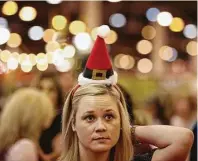  ?? Yi-Chin Lee / Houston Chronicle ?? Aneta Locke wears a seasonal headband on Sunday while shopping at the Nutcracker Market at NRG Center.