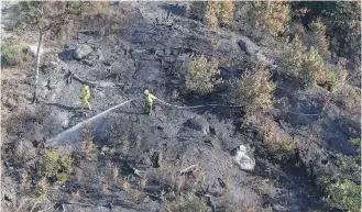  ?? COMMUNICAT­IONS NOVA SCOTIA ?? A fire crew works at the Maitland Bridge in Annapolis County, N.S.