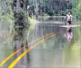  ?? John Fitzhugh ?? The Sun Herald Britt Singletary walks down Brandon James Drive to his car parked Friday outside the Wells Ferry Landing subdivisio­n in Biloxi, Miss.