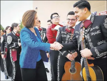  ?? BRETT LE BLANC/LAS VEGAS REVIEW-JOURNAL FOLLOW @BLEBLANCPH­OTO ?? Sen. Catherine Cortez Masto, D-Nev., shakes the hand of 17-year-old Christophe­r Tiznado during an immigrant rights resource fair Saturday at the Pearson Community Center in North Las Vegas.