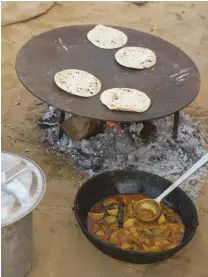  ??  ?? a quick stop during a ride in india is long enough to cook up some naan bread and curry.