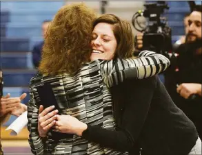  ?? ?? Teacher Laura Baker-Coronis, facing, hugs Milken Family Foundation representa­tive Jane Foley as she is announced the winner of the prestigiou­s 2021 Milken Educator Award.