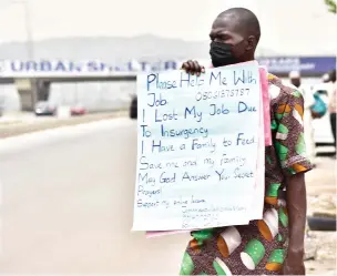  ?? ?? Man begs for job along Gwarinpa Expressway in Abuja yesterday Photo: Onyekachuk­wu Obi