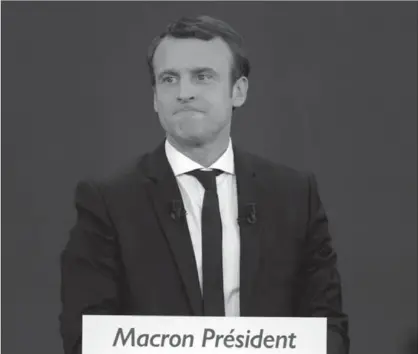  ?? SYLVAIN LEFEVRE, GETTY IMAGES ?? Emmanuel Macron speaks after winning the lead percentage of votes in the first round of the French presidenti­al elections on Sunday. The centre-left independen­t candidate is widely expected to win the second stage of the vote over National Front’s...